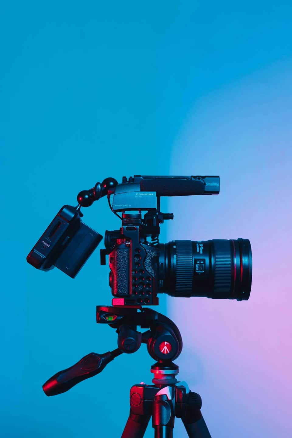 Videocamera professionale su treppiede con microfono e monitor.